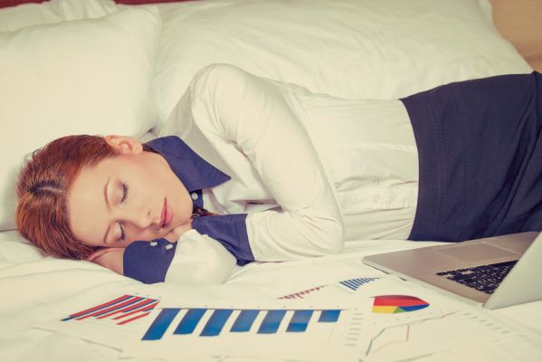 Businesswoman asleep on the bed, hotel or domestic room
